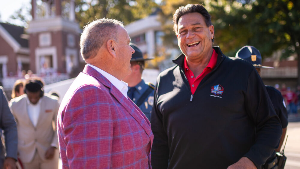 Former Arkansas Razorback football coach Sam Pittman with former Hog and Chicago Bear Dan Hampton before a game